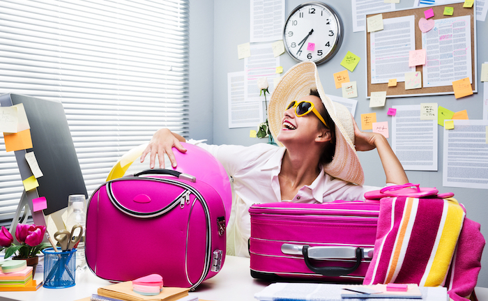 How to Bounce Back from Vacation | Laundry Care Happy woman with suitcases filled with clean clothes from Laundry Care