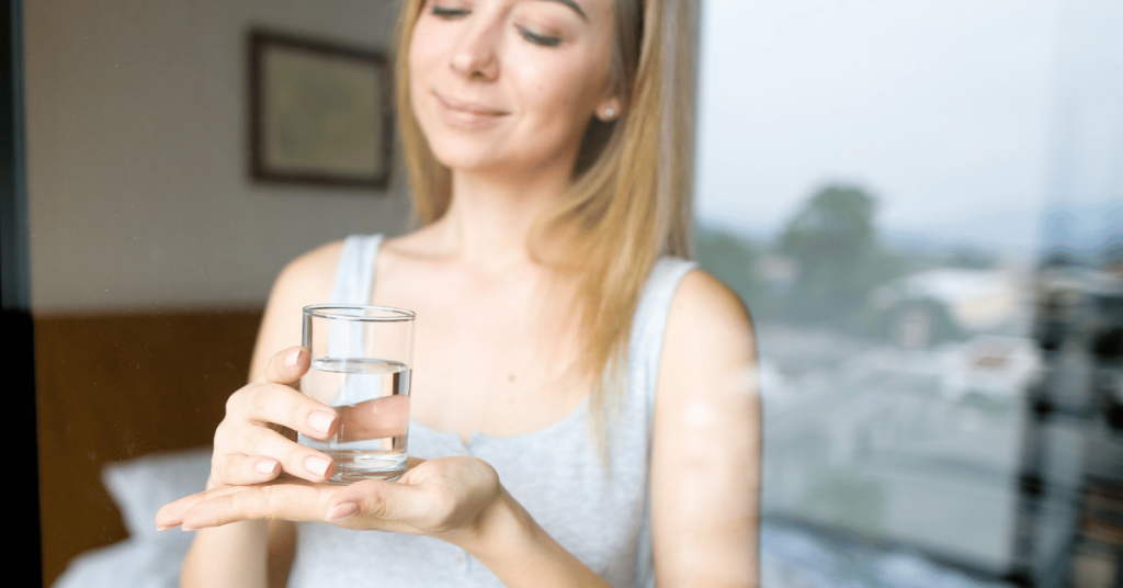 Happy woman with clean glass of water.